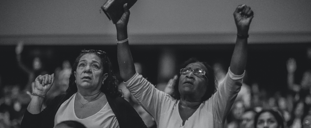 Two older women preaching god's name