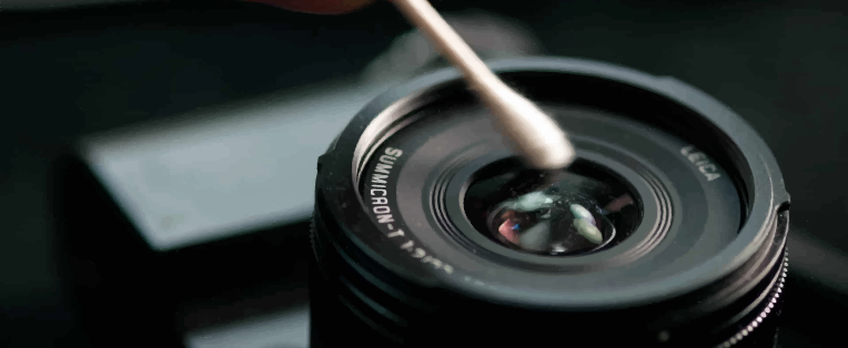 Cleaning camera lens with ear cotton stick