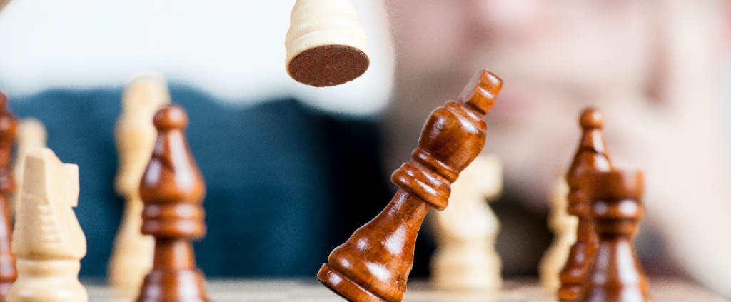 Chess figures, white figure crushing black king