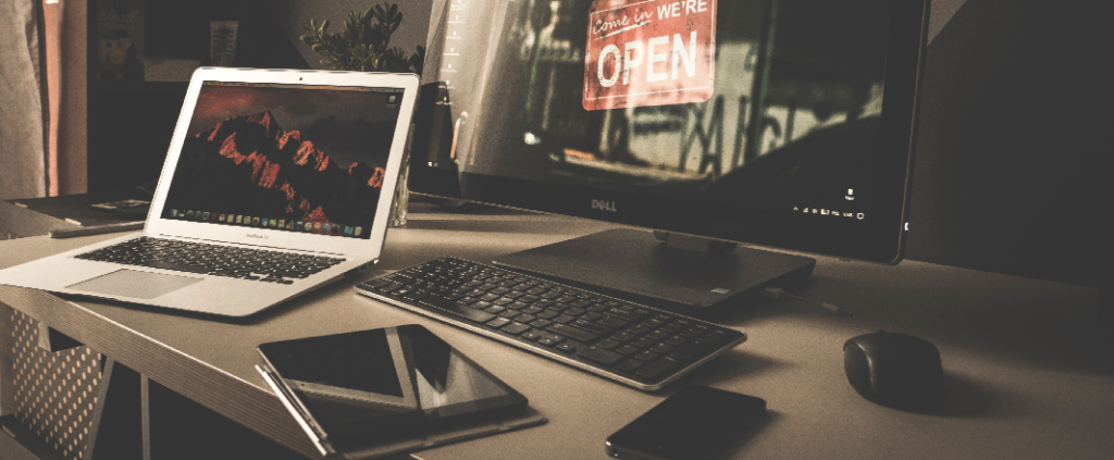 All devices on one desk. Smartphone, laptop, mouse, keyboard, tablet