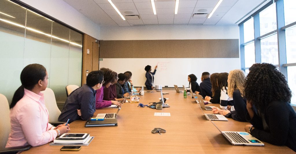 People sitting at one table listening to a conference