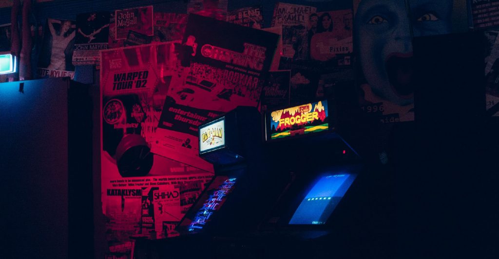 Stranger Things and Vaporwave atmosphere room with old school arcade game machines and a wall full of vintage movie poster. Post